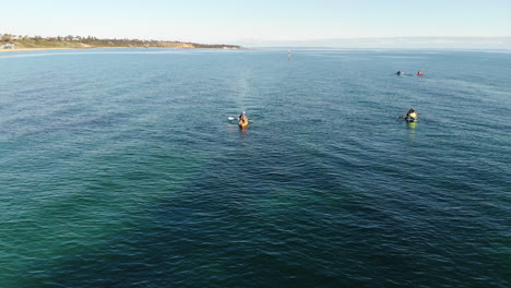 Aerial-flight-over-kayakers-enjoying-the-water-in-Sandringham,-Melbourne,-Australia