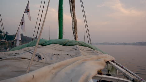 Sailing-along-the-Nile-River-in-Egypt-at-sunset---panoramic-pan