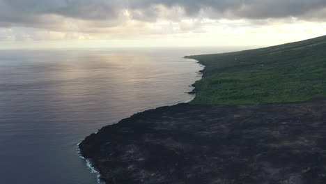 Aerial-flight-over-the-dried-lava-flow-into-the-ocean-from-a-volcanic-eruption-on-Reunion-Island