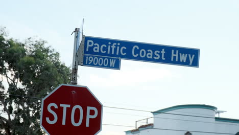 Road-highway-sign-direction-board-of-pacific-coast,-in-California,USA-with-clear-skies-in-the-background