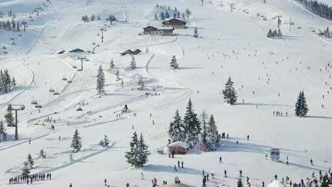 4k-Drone-Aerial-of-people-doing-Winter-sport-in-the-Alps,-Flachau,-Austria