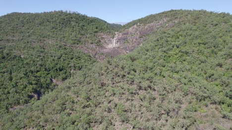 Jourama-Falls-Surrounded-With-Lush-Tropical-Vegetation-In-Paluma-Range-National-Park,-North-Queensland,-Australia---aerial-drone-shot