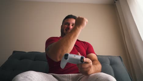 Young-man-celebrating-victory-playing-video-games