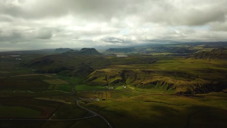 Aerial-landscape-view-of-Iceland-mountain-grasslands,-on-a-cloudy-day