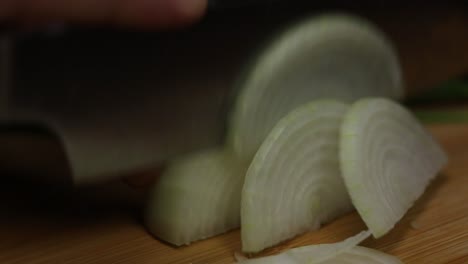 Slow-motion-shot-of-chopping-onion,-process-of-preparing-vegetables-to-cook-meals