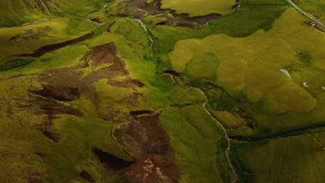 Aerial-landscape-view-of-a-river-flowing-in-a-mountain-gorge,-in-Iceland