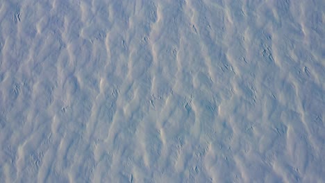 Aerial-TOPDOWN-flying-backwards-over-the-patterns-in-the-fresh-snow