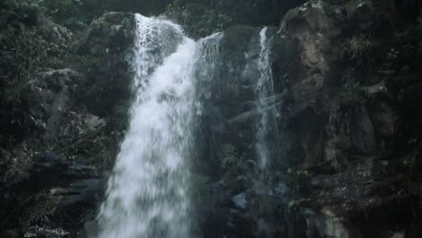 Tilt-down-view-of-a-rainforest-waterfall-in-Panama