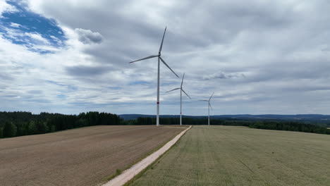 Windmills-in-Countryside-Landscape-Aerial-View-of-Wind-Turbines-Under-Cloudy-Sky