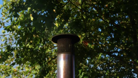 Metallic-Flue-With-Steam-And-Heat-Being-Expelled-Under-Forest-Canopy