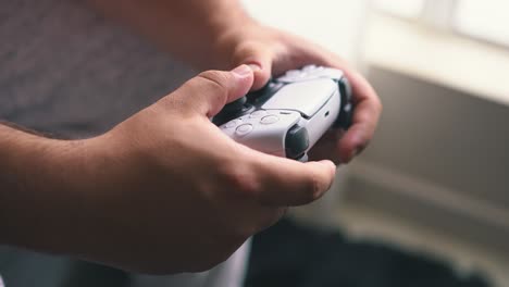 Close-up-of-hands-playing-video-game-at-living-room-in-slow-motion