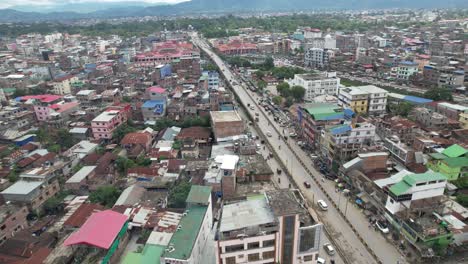 Aerial-Drone-Shot-Of-Highway-Near-Imphal-Market-In-Manipur,-India