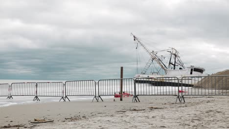 Timelapse-of-shrimp-boat-stuck-on-the-beach-during-a-cloudy-day