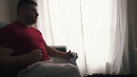 Young-man-celebrating-a-victory-on-video-games-at-his-living-room-in-slow-motion