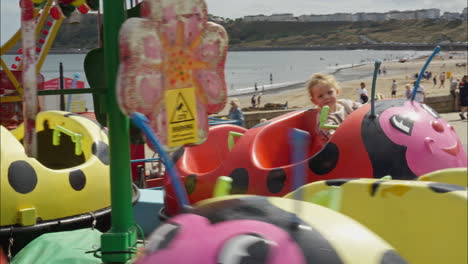 Happy-little-girl-rides-on-a-carousel-amusement-park-ride