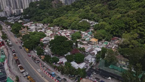 Aerial-drone-rotating-shot-over-Cha-Kwo-Ling-village,-Hong-Kong,-China