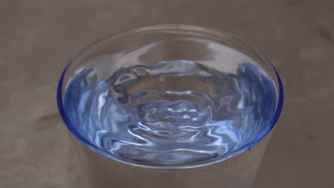 A-ripple-effect-in-a-transparent-glass-of-water