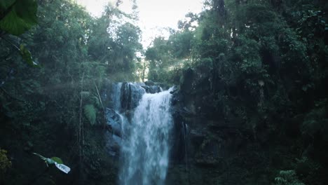 Walking-towards-a-waterfall-in-a-rainforest