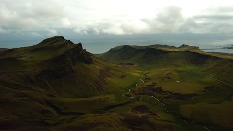 Aerial-landscape-view-of-a-river-flowing-in-a-mountain-valley,-in-Iceland