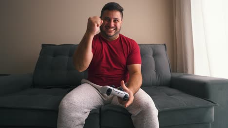 Guy-playing-video-games-excited-victory-front-view-slow-motion