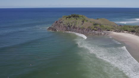 Aerial-View-Of-Norries-Headland-And-Surfers-On-The-Ocean-In-Cabarita-Beach,-New-South-Wales,-Australia---drone-shot