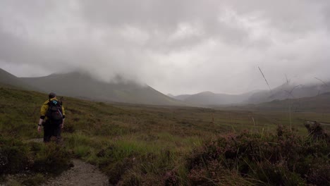 Hiking-Walking-Down-a-Mountain-Trail-Through-the-Scottish-Mountains