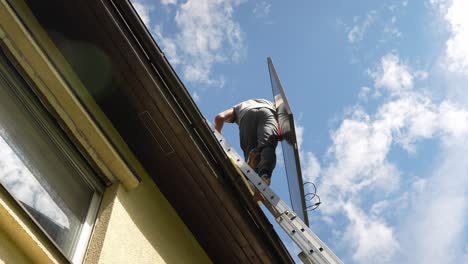 PV-professional-techincian-climbing-lather-to-install-high-end-solar-panel