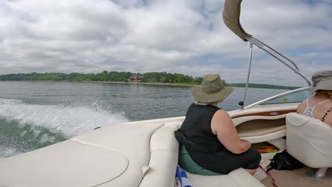 Slow-Motion-of-Woman-in-rear-of-cockpit-of-sports-boat-this-is-cruising-on-Table-Rock-Lake-on-a-cloudy-afternoon