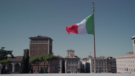 Waving-Italian-Flag-In-The-Historical-City-Center-Of-Rome,-Italy