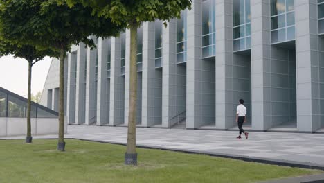 Adult-Asian-man-walking-outside-of-Modern-office-building,-Business-concept,-Slow-motion