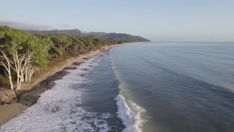 Wangetti-Beach-With-Ocean-Waves-Crashing-On-The-Shore-In-North-Queensland,-Australia---drone-shot