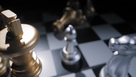 Shot-sliding-over-a-chessboard-with-a-golden-king-piece-standing-proudly-over-the-rest