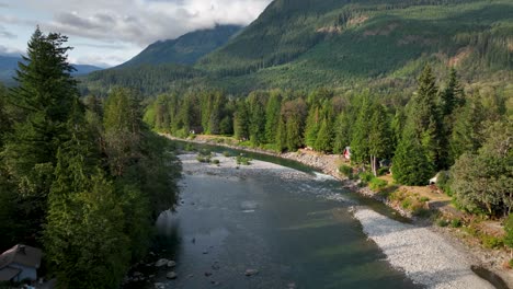 Aerial-view-of-the-Skykomish-River-passing-through-Baring,-Washington-on-a-sunny-evening