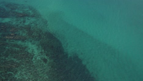 Reef-Rocks-Submerged-Under-Turquoise-Blue-Sea