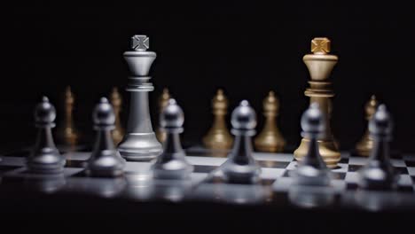 Chess-match-stand-off-between-silver-and-gold-kings-backed-by-their-pawns