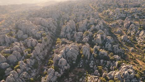 Aerial-drone-forward-moving-shot-over-beautiful-rock-formation-in-El-Torcal-de-Antequera-Nature-reserve,-Spain-during-evening-time