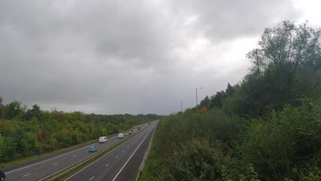 M4-Motorway-Freeway-Static-Shot-of-Cars-Passing-and-Dramatic-Dark-Cloudy-Sky-4K