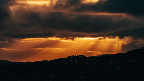 Stunning-timelapse-shot-of-golden-sunrays-appearing-through-the-clouds