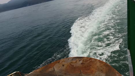 Traveling-Ferry-Boat-With-Rusted-Rear-Leaving-Wake-Across-The-Water-In-Orcas-Island,-San-Juan-County,-Washington
