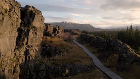 Isolated-and-unrecognizable-people-walking-on-walkway-crossing-fault-or-crack-of-Thingvellir-National-Park