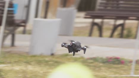Tracking-shot-of-a-DJI-FPV-drone-as-it-moves-across-and-its-movement-is-controlled