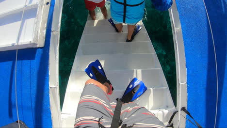 A-tourists\person-walking-on-steps-with-snorkeling-fins-on-|-person-with-snorkeling-fins-moving-towards-water-from-stairs-video-background