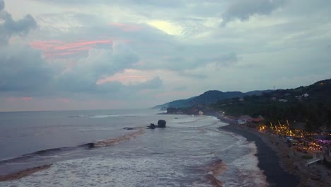 El-Tunco-beach-shoreline-during-an-overcast-afternoon-in-El-Salvador---Drone-dolly-in