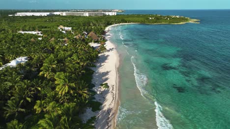 Aerial-view-over-a-quiet,-paradise-beach-in-sunny-Xpu-Ha,-Quintana-Roo,-Mexico