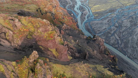 Flyover-above-cliffs,-river-valley-of-Thorsmork,-Iceland,-or-the-Valley-of-Thor