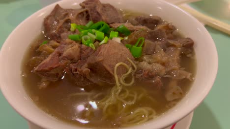 Traditional-chinese-beef-brisket-noodle-soup-with-spring-onion,-delicious-asian-cuisine,-very-hot-broth,-4K-shot