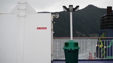 'No-Smoking'-sign-at-the-aft-of-a-ferry-that-steers-through-coastal-waters-of-New-Zealand-on-an-overcast-evening