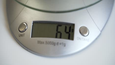 Numbers-on-digital-scale-display-changing-while-weighing-in-grams