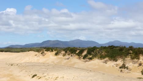 Coastal-sand-dunes-with-big-mountains-in-the-background-in-southern-Victoria