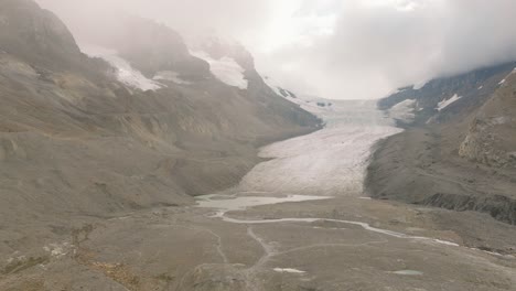 Aerial-dolly-in-of-Columbia-Icefield-Glacier-between-Canadian-Rockies-mountains-at-Banff-National-Park,-Alberta,-Canada